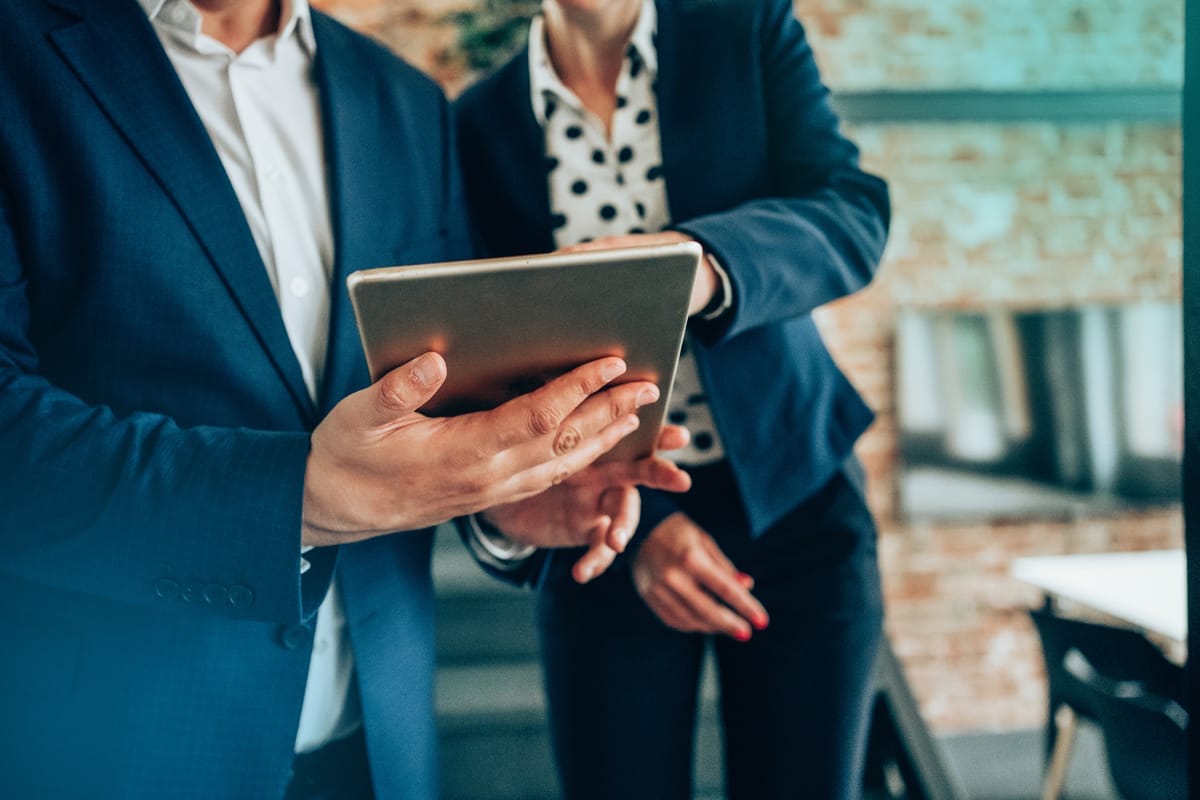 A photo of hands holding a tablet device